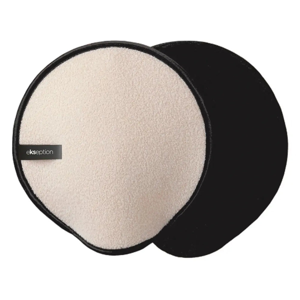 Beige och svart handske med textur, stående på ljus bakgrund – en peelinghandske som tar bort döda hudceller och förbereder huden för självbruning.