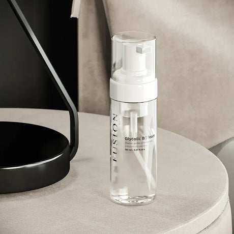 Vit flaska med svart text, stående på ljus bakgrund – en rengöringsprodukt som reducerar pigmentering och jämnar ut hudtonen.